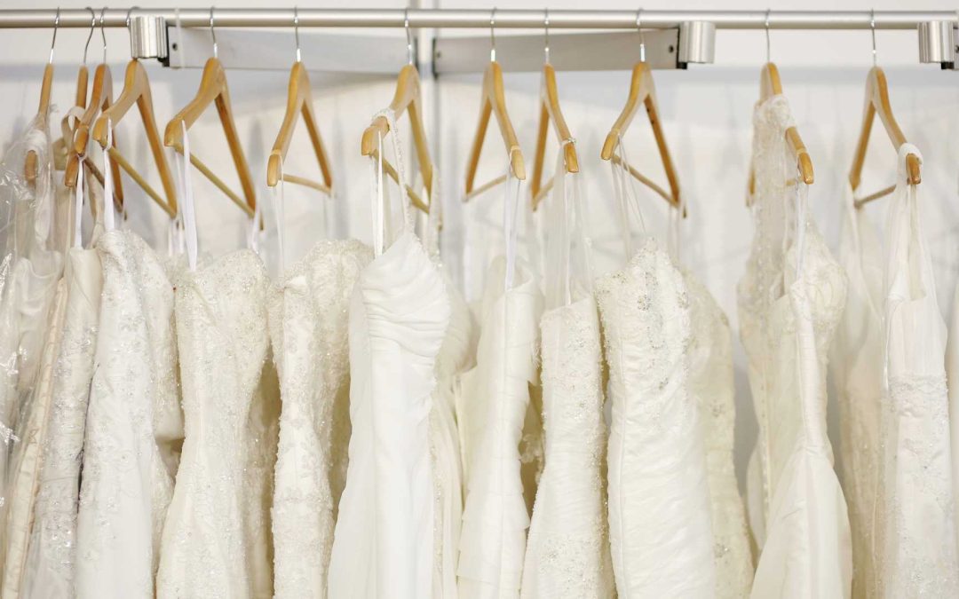 a rack of wedding dresses