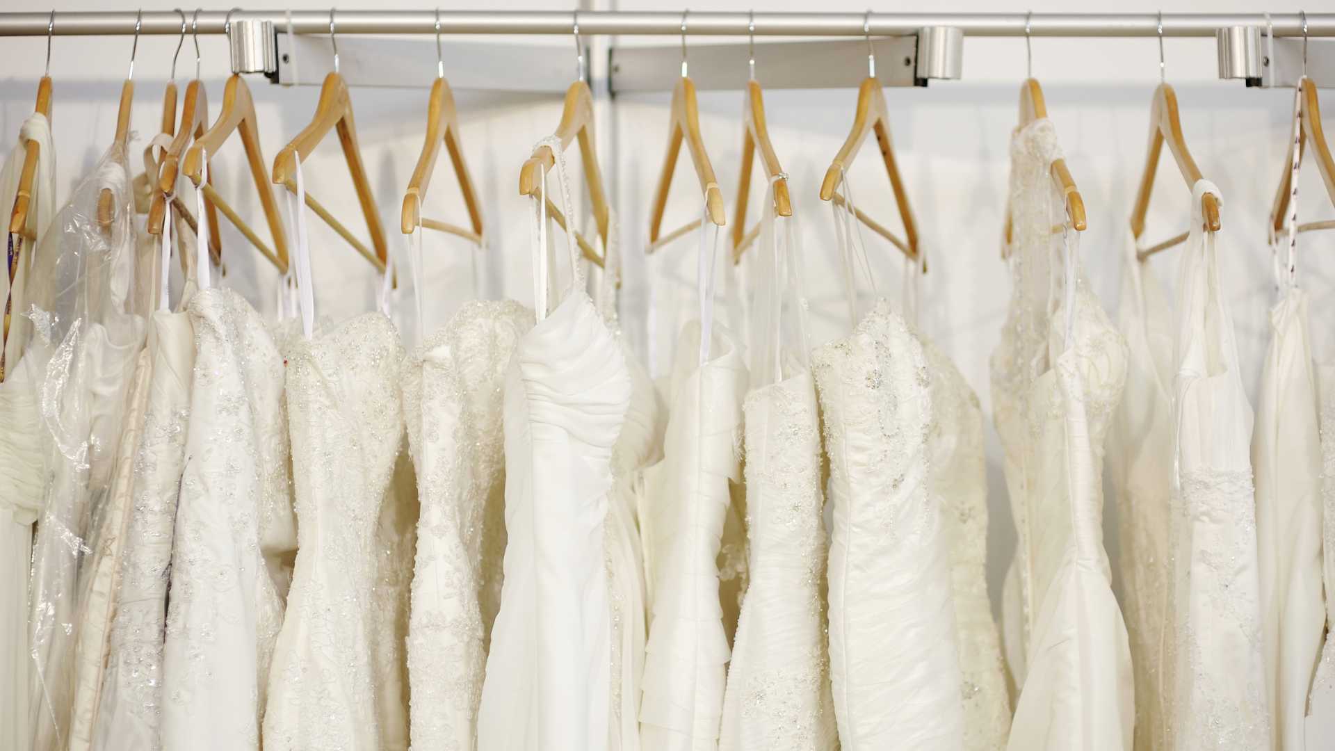 a rack of wedding dresses