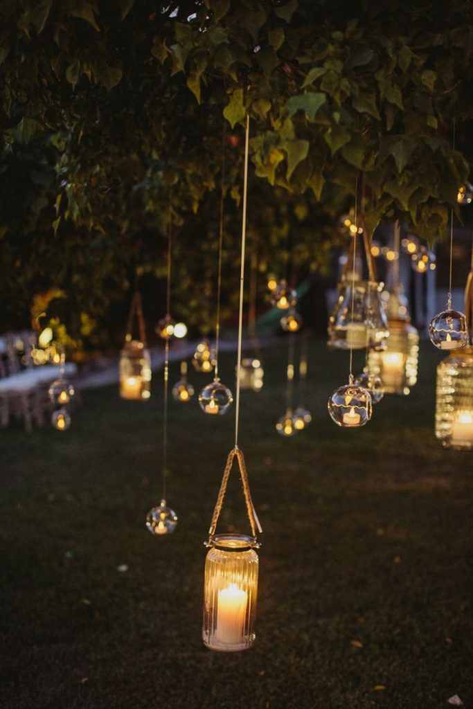 Lanterns hanging from tree for wedding decor.